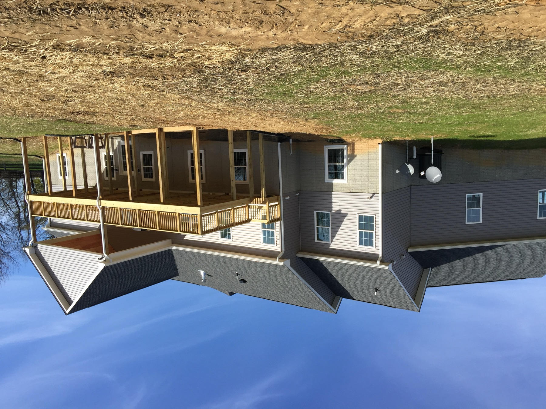 Completed custom home with a covered deck built on a private lot