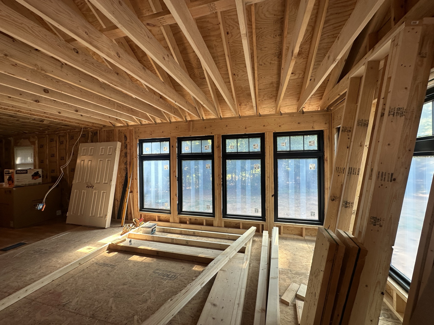 Custom home interior framing with a wall of black-trimmed windows